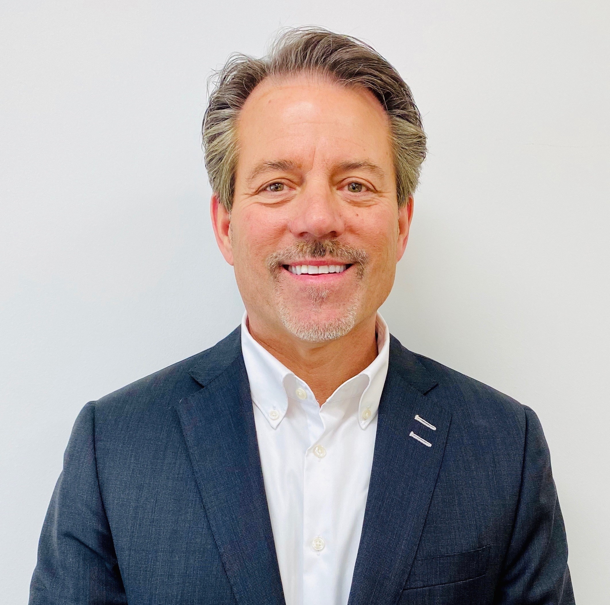 Bill O'Hara, Vice President and General Manager at Mercedes-Benz of Hoffman Estates, a Zeigler Auto Group dealership, poses for a professional portrait showcasing his leadership in the automotive industry.