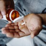 A person holding a blister pack of non narcotic medicine, symbolizing relief from anxiety disorders