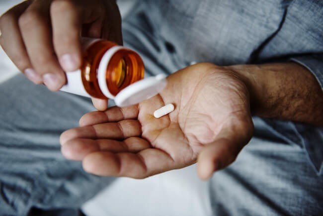 A person holding a blister pack of non narcotic medicine, symbolizing relief from anxiety disorders