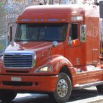 Freightliner Columbia semi truck, showcasing shared parts with Mercedes-Benz, hauls logs