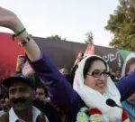 Pakistani former premier Benazir Bhutto waves to her supporters as she arrived for an election campaign rally in Rawalpindi 27 December 2007.