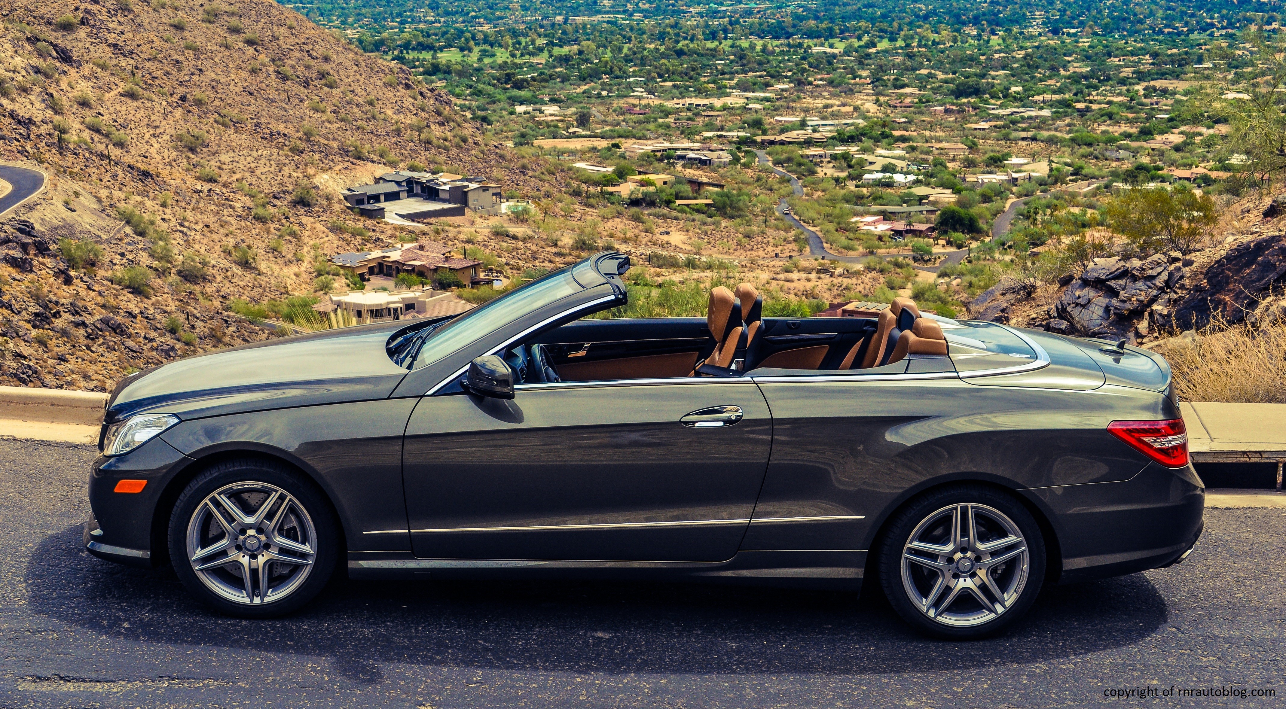 Front quarter view of a pre-facelift 2013 Mercedes-Benz E550 Convertible showcasing its split headlights and elegant design