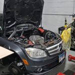 Technicians working on a Mercedes Benz engine