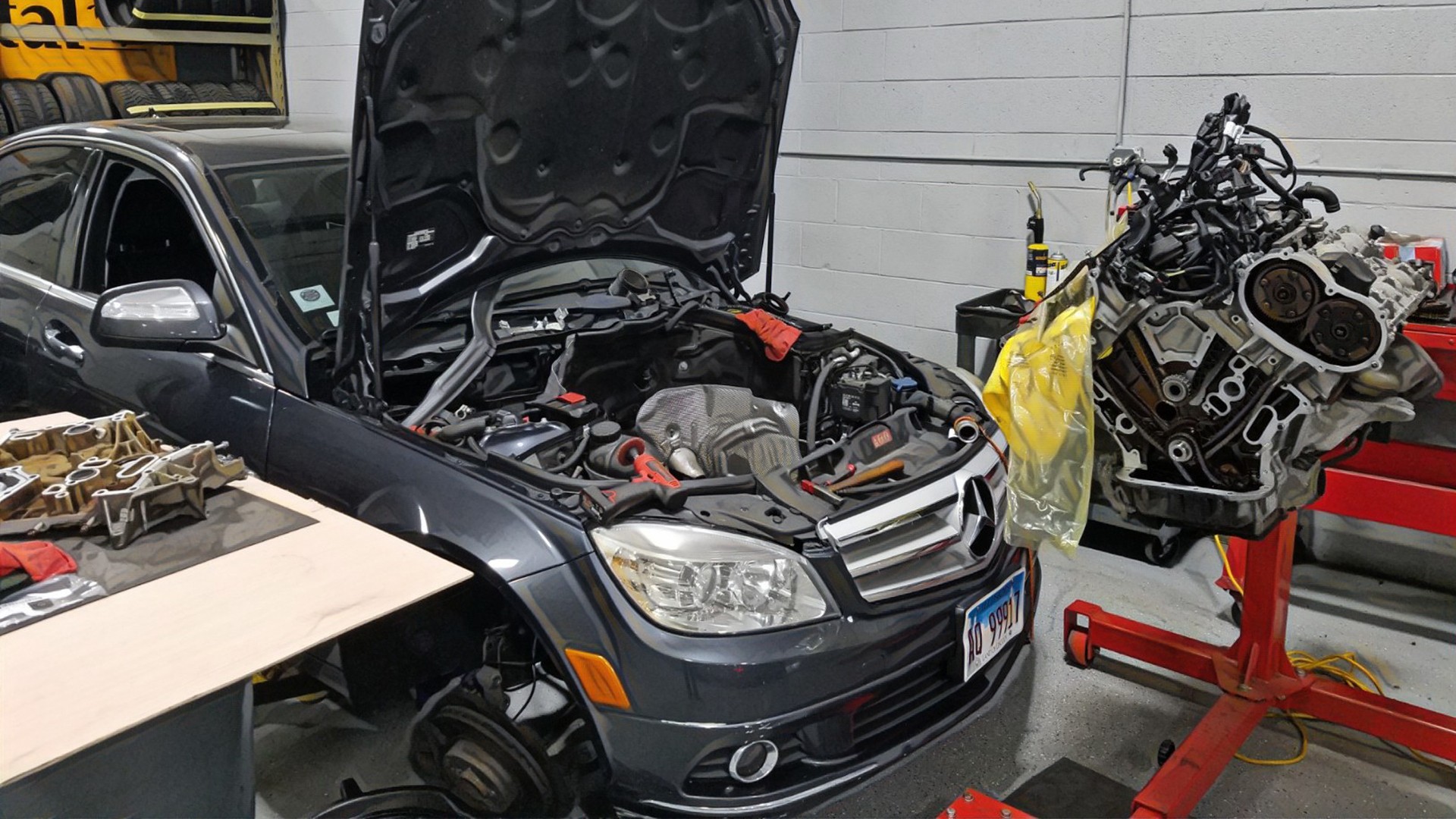 Technicians working on a Mercedes Benz engine