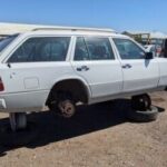 Front side view of a clean 1994 Mercedes-Benz E 320 wagon in a junkyard, showcasing its well-preserved condition