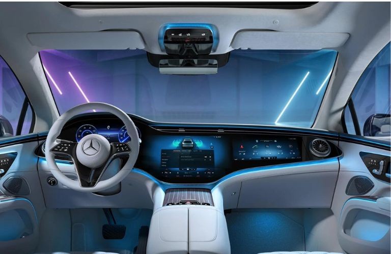 Mercedes-Benz dashboard illuminated with blue ambient lighting, showcasing the elegant interior