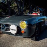 Front view of the dolphin grey Mercedes-Benz 190SL, showcasing its iconic grille and headlights.