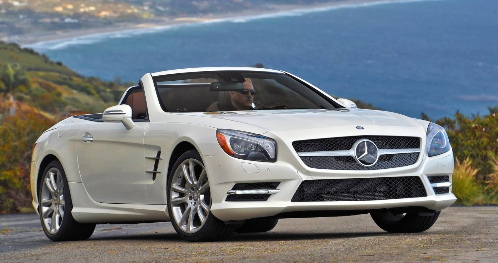 A 2013 Mercedes-Benz SL550 roadster, emphasizing its sporty convertible design and classic Mercedes-Benz styling.