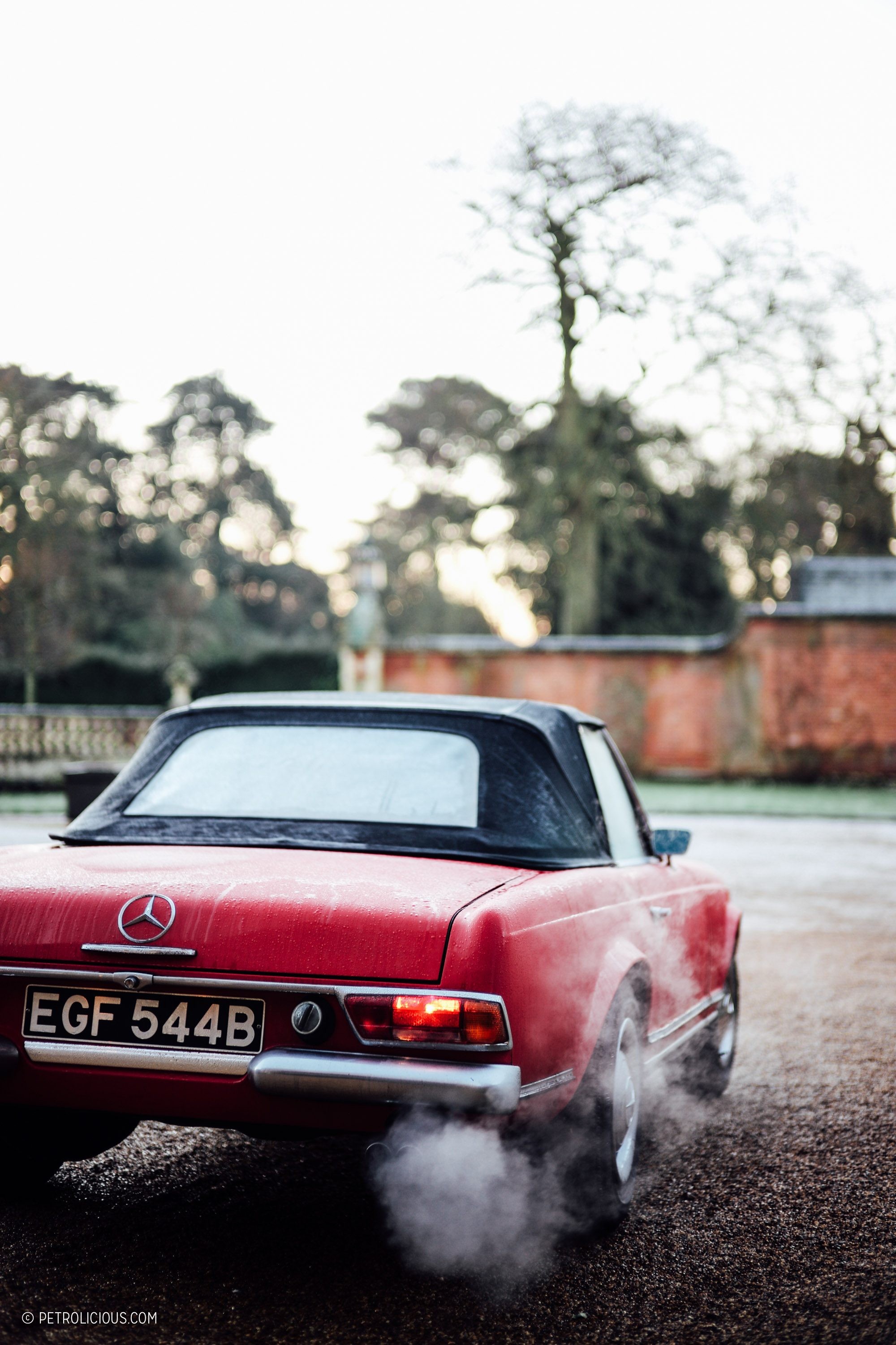 Front view of a red Mercedes Benz 230 SL Pagoda, showcasing its classic design.