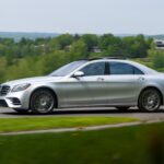 Front exterior view of a silver 2018 Mercedes-Benz S560 luxury sedan parked on a paved area showcasing its elegant design and iconic grille.